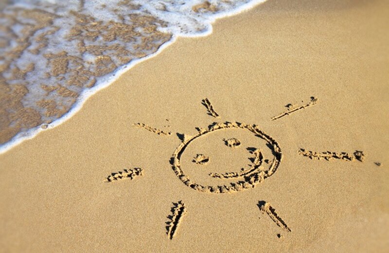 Smiley Sun Drawn in Sand