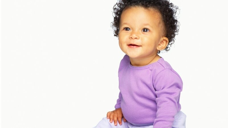 smiling baby in purple shirt