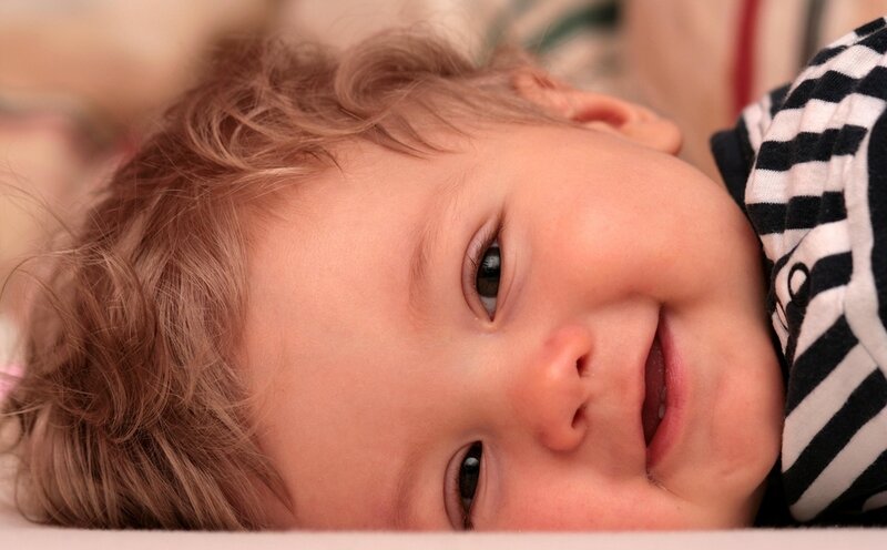 smiling baby in striped shirt