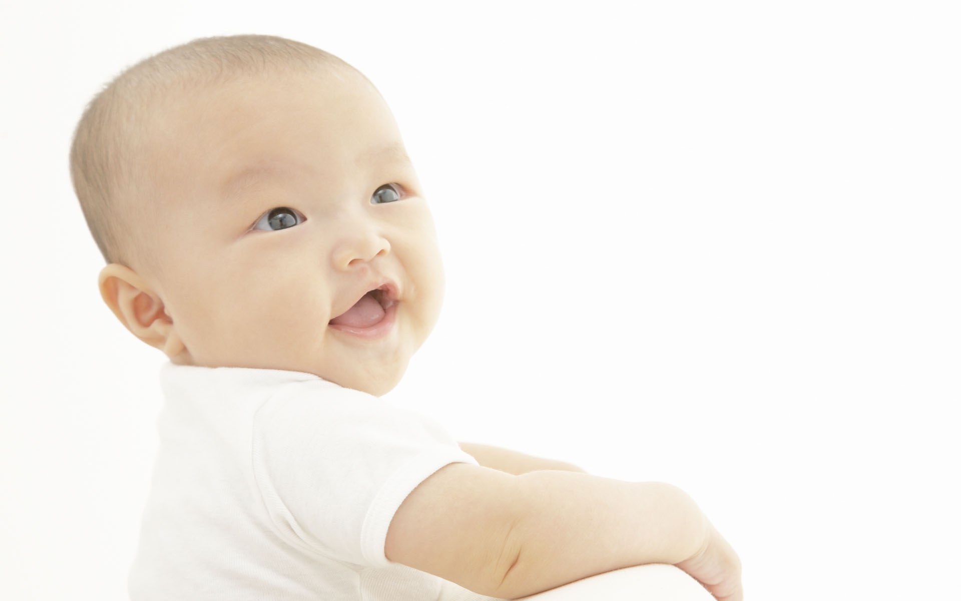 smiling baby in white