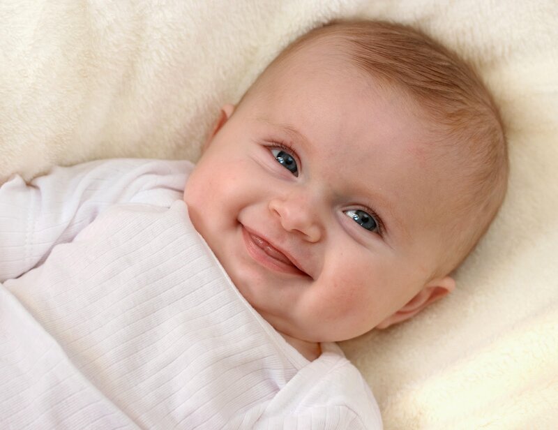 Smiling Baby Lying Down — White