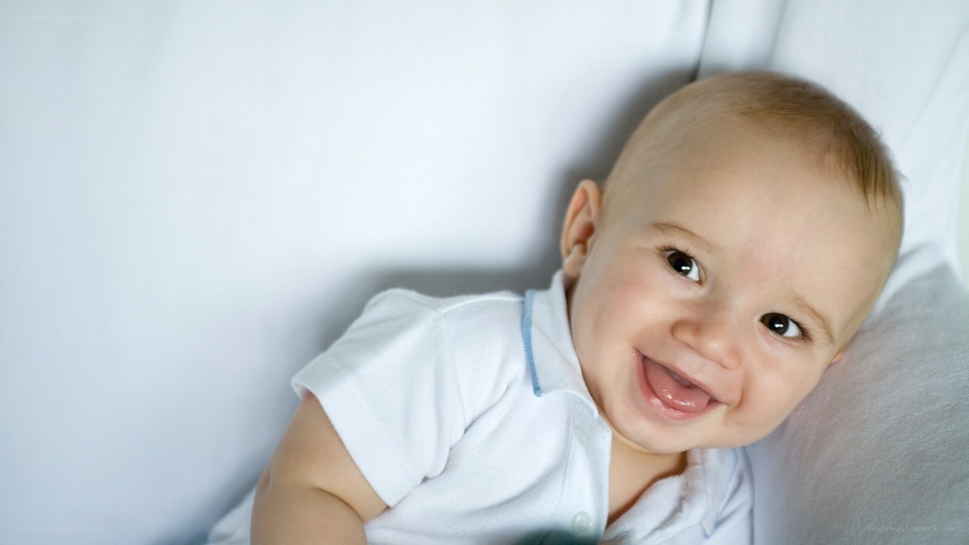 smiling baby lying on back