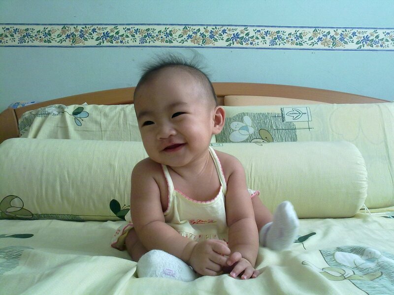smiling baby on bed
