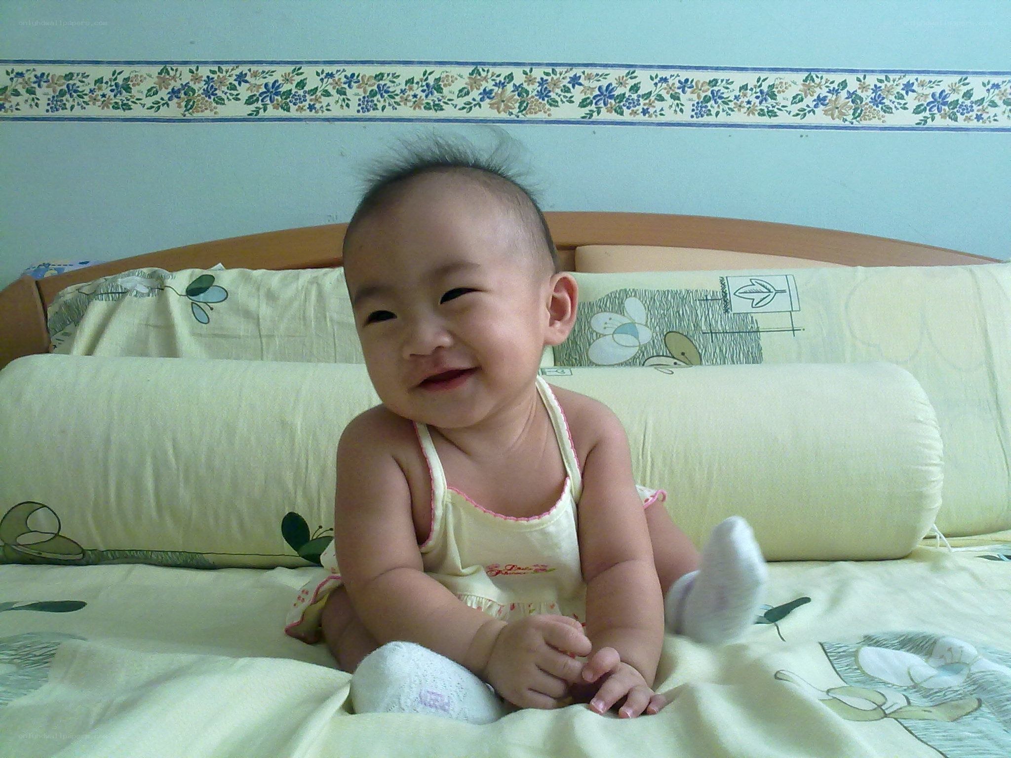 smiling baby on bed