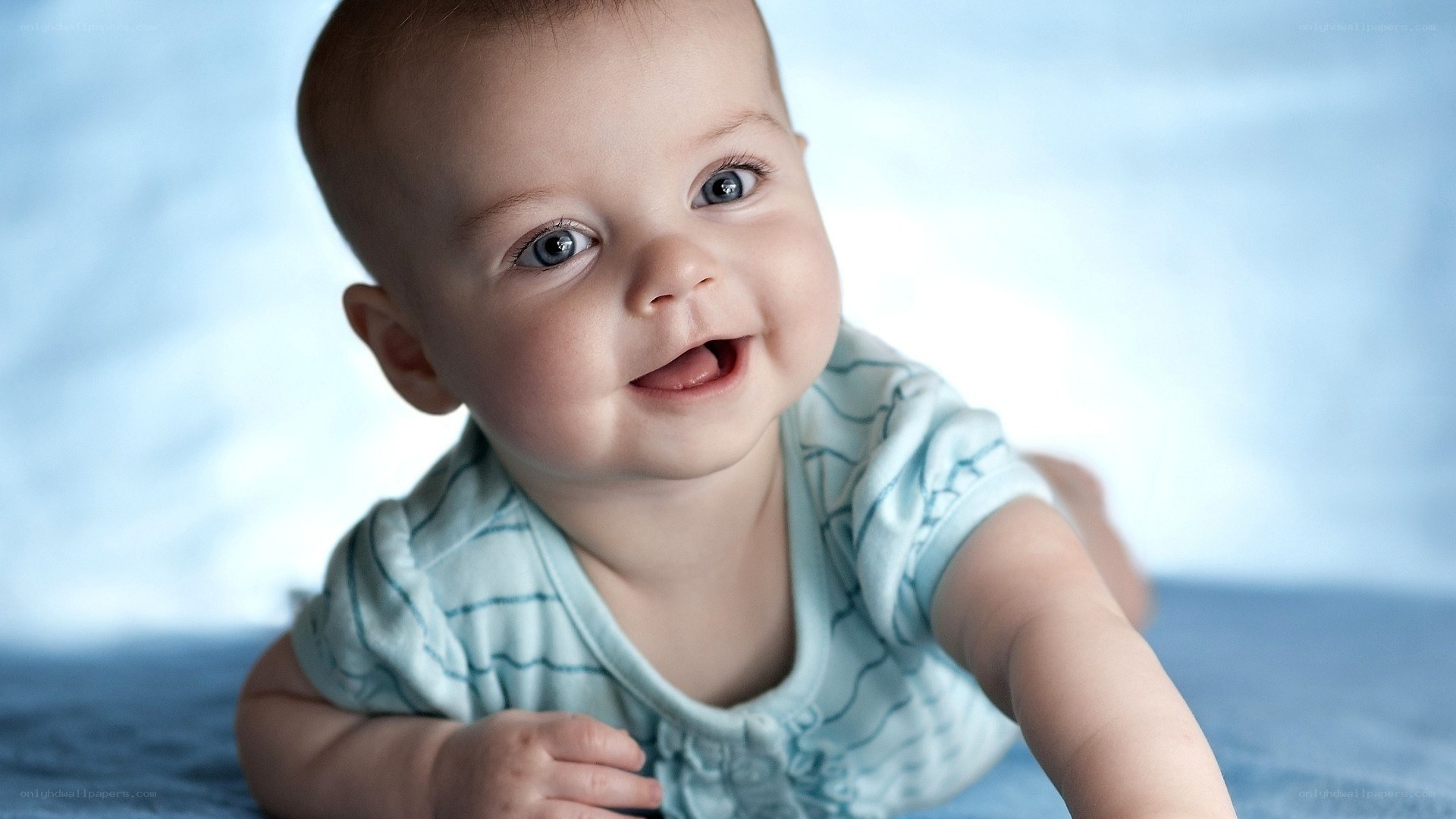 smiling baby on blue blanket