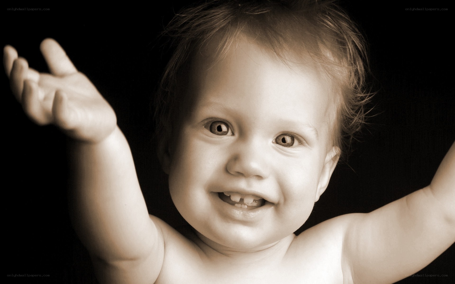 smiling baby with arms raised
