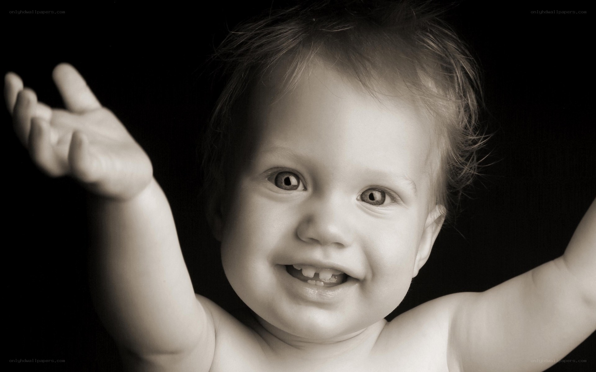 smiling baby with raised arms