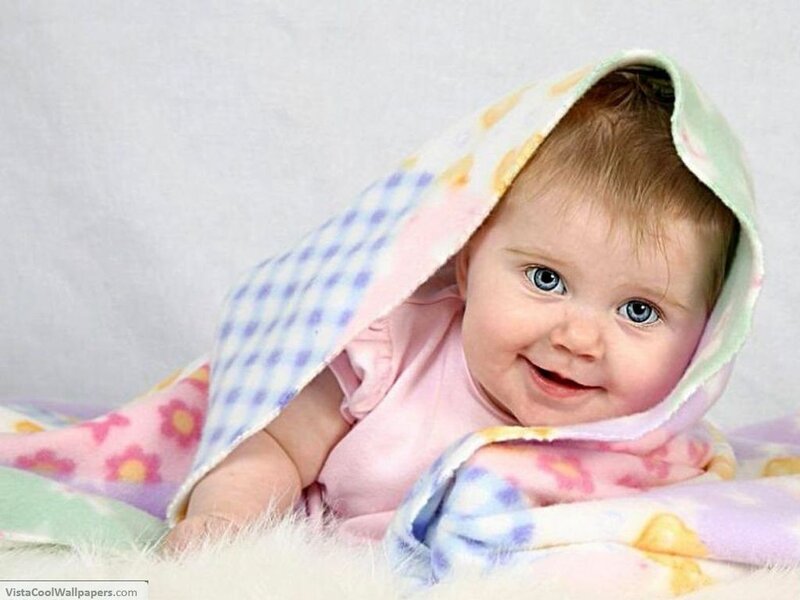 smiling baby wrapped in blanket