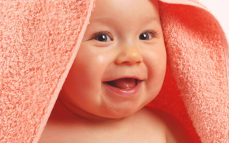 Smiling Baby Wrapped in Towel — Pink