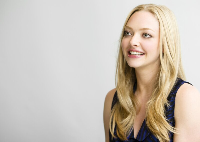 smiling blonde woman in blue top