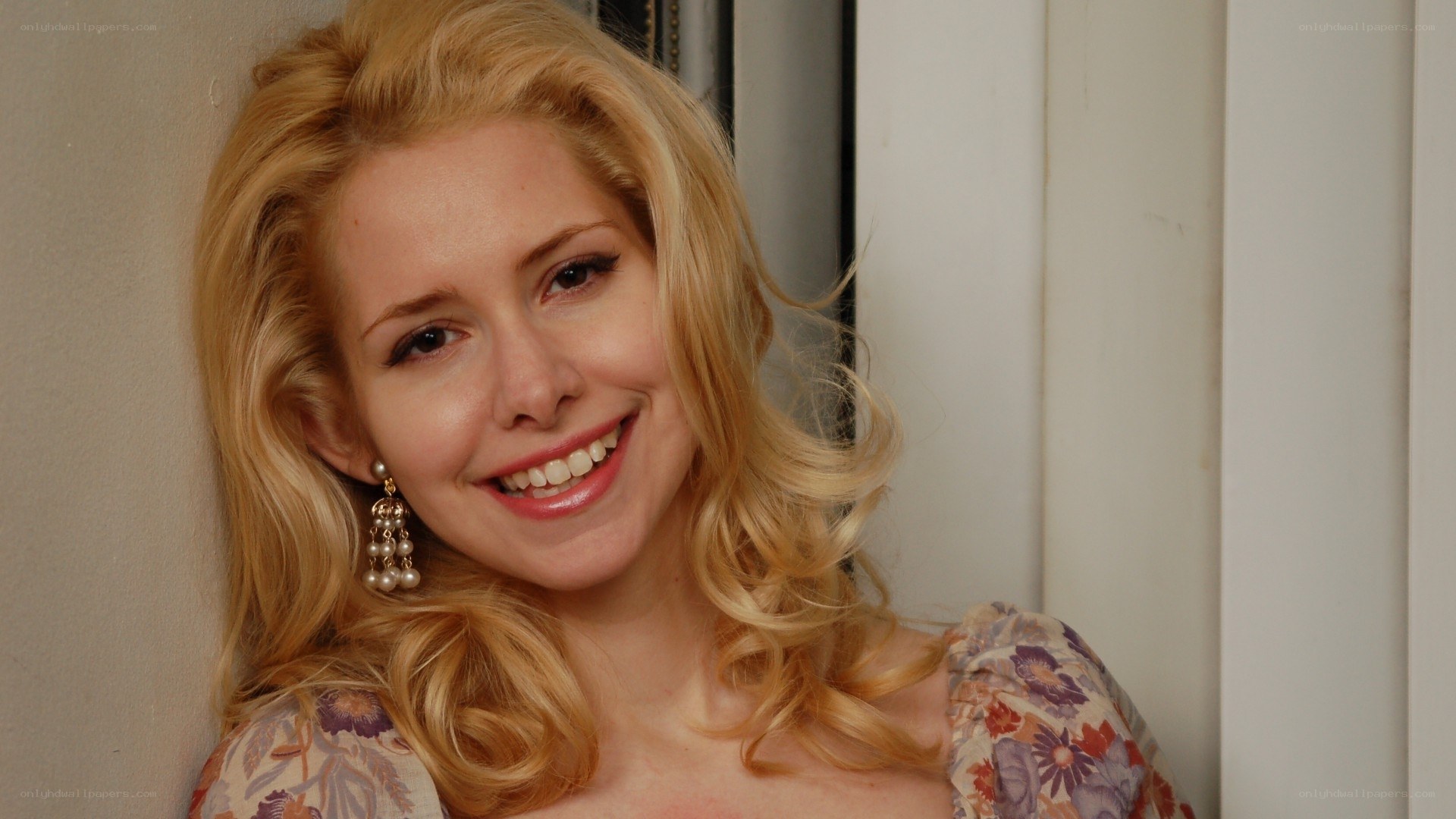 smiling blonde woman in floral dress