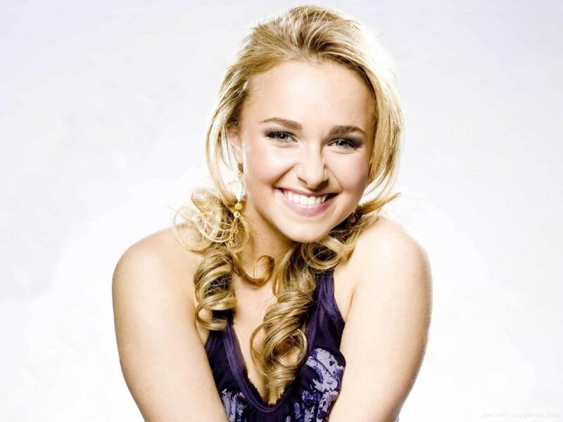 Smiling blonde woman in purple top