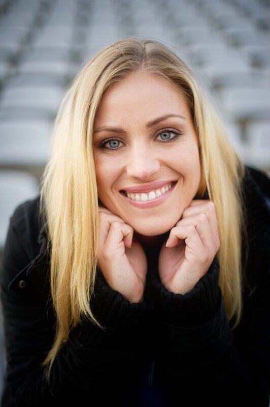 smiling blonde woman in stadium