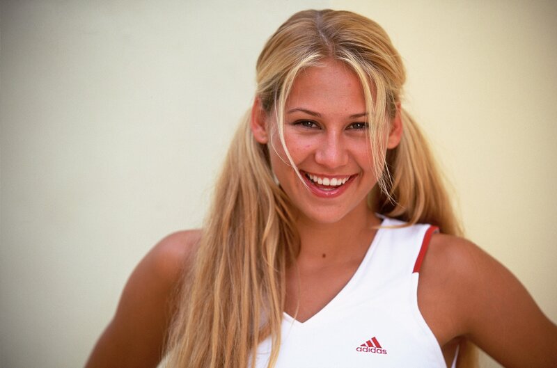 smiling blonde woman in white top