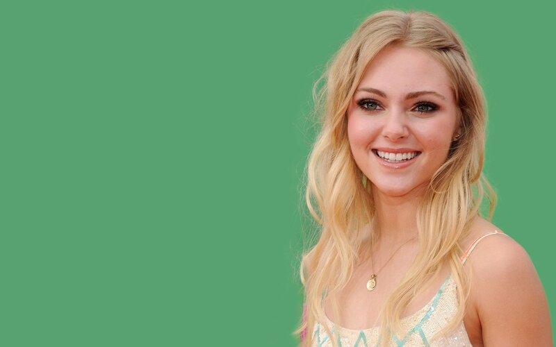 smiling blonde woman on green