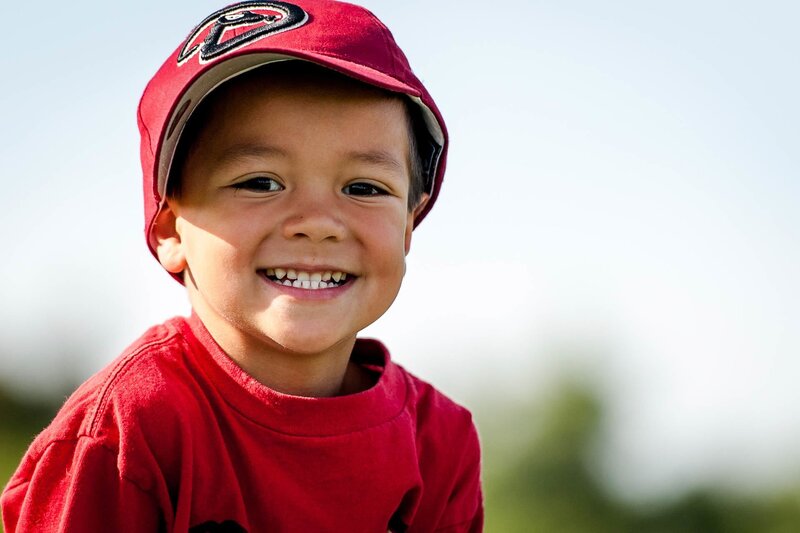 smiling boy in red cap