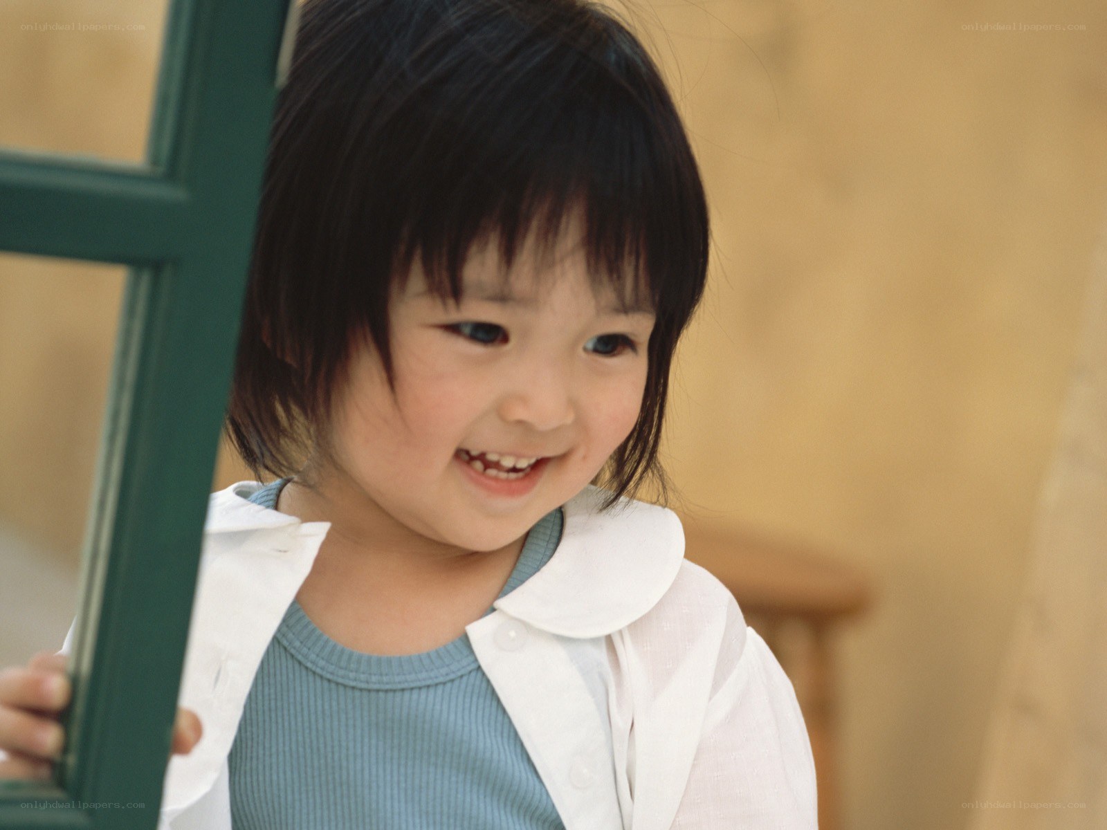 smiling child holding frame