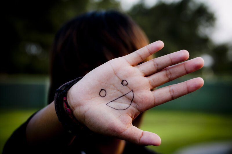 smiling face on palm