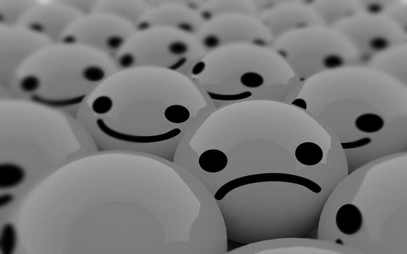 smiling faces with one sad face
