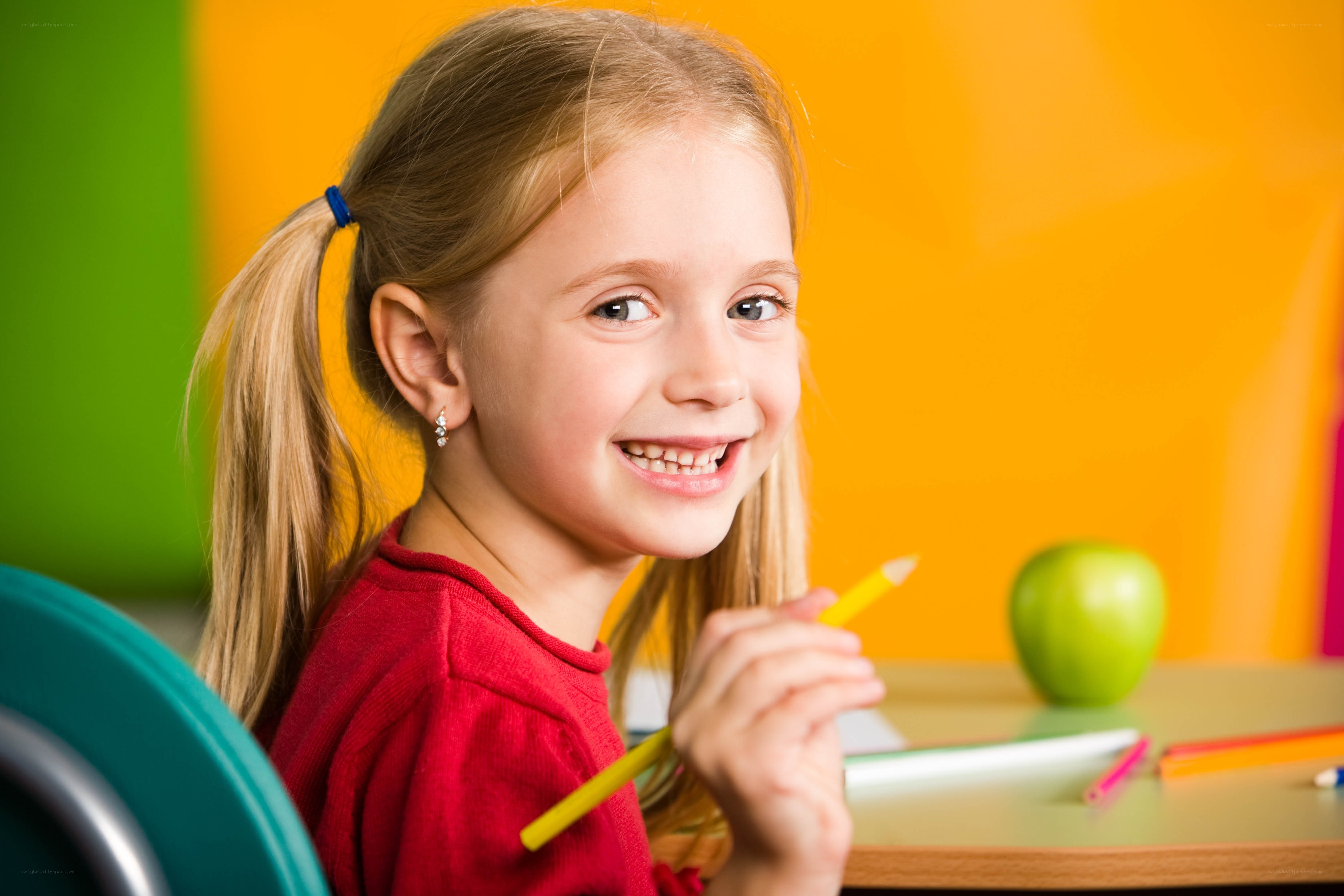 smiling girl at school desk