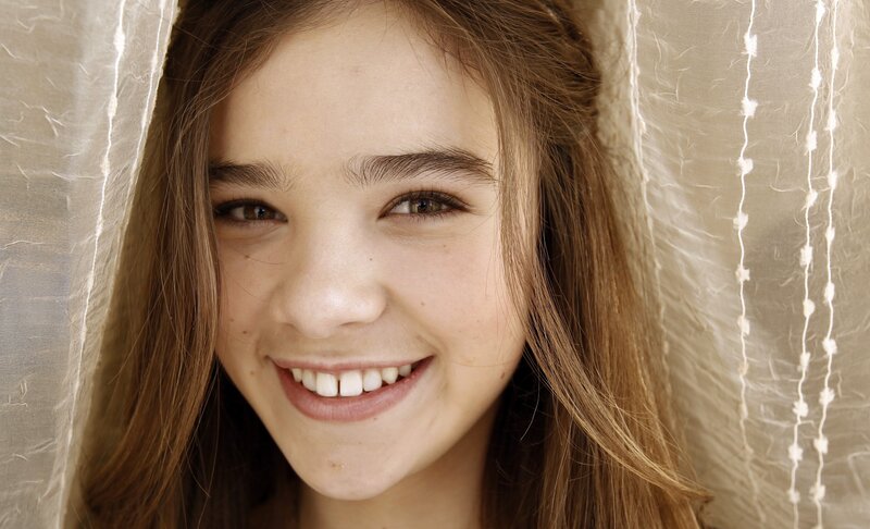 smiling girl behind curtain