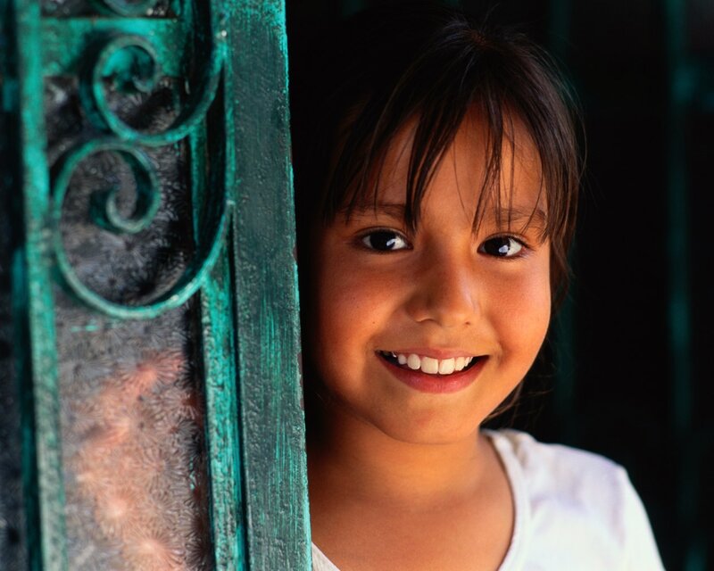 smiling girl by green gate