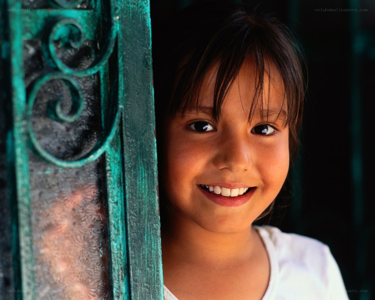smiling girl by green gate