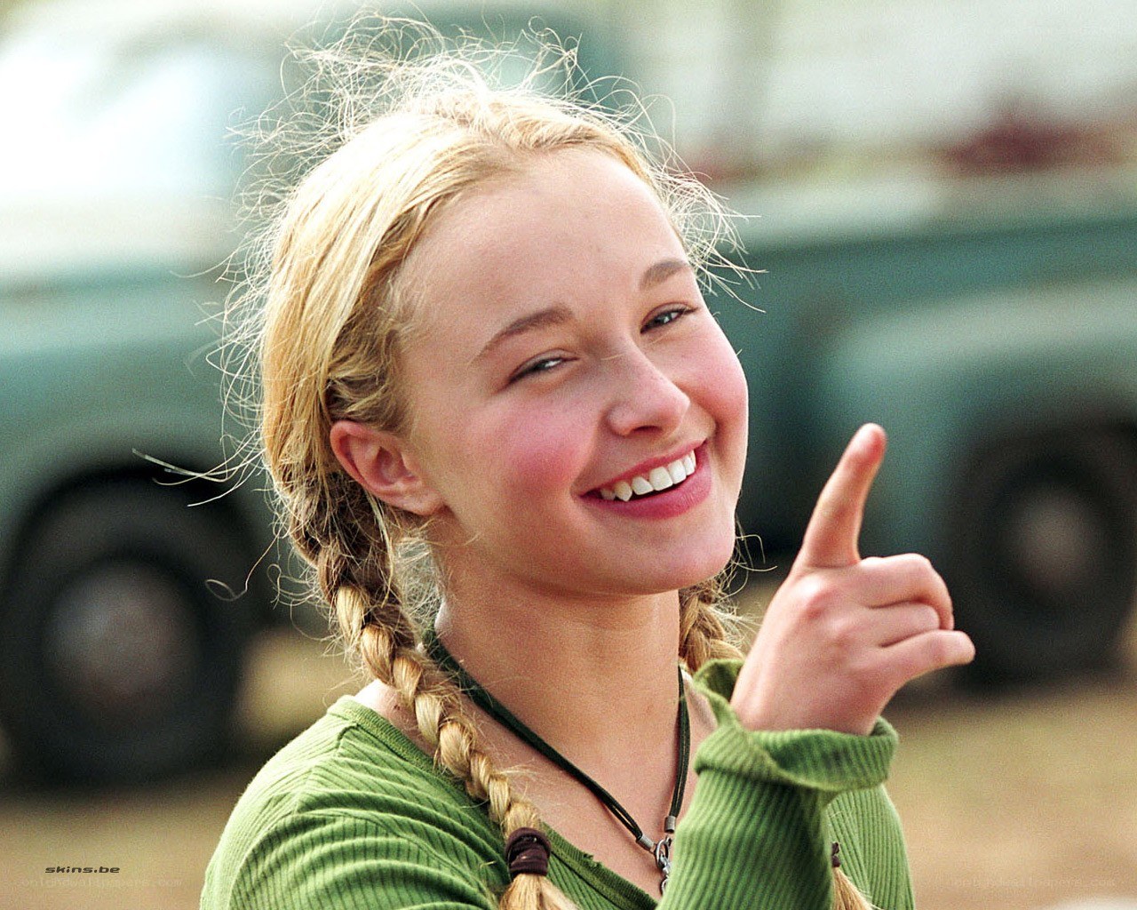 Smiling girl pointing up