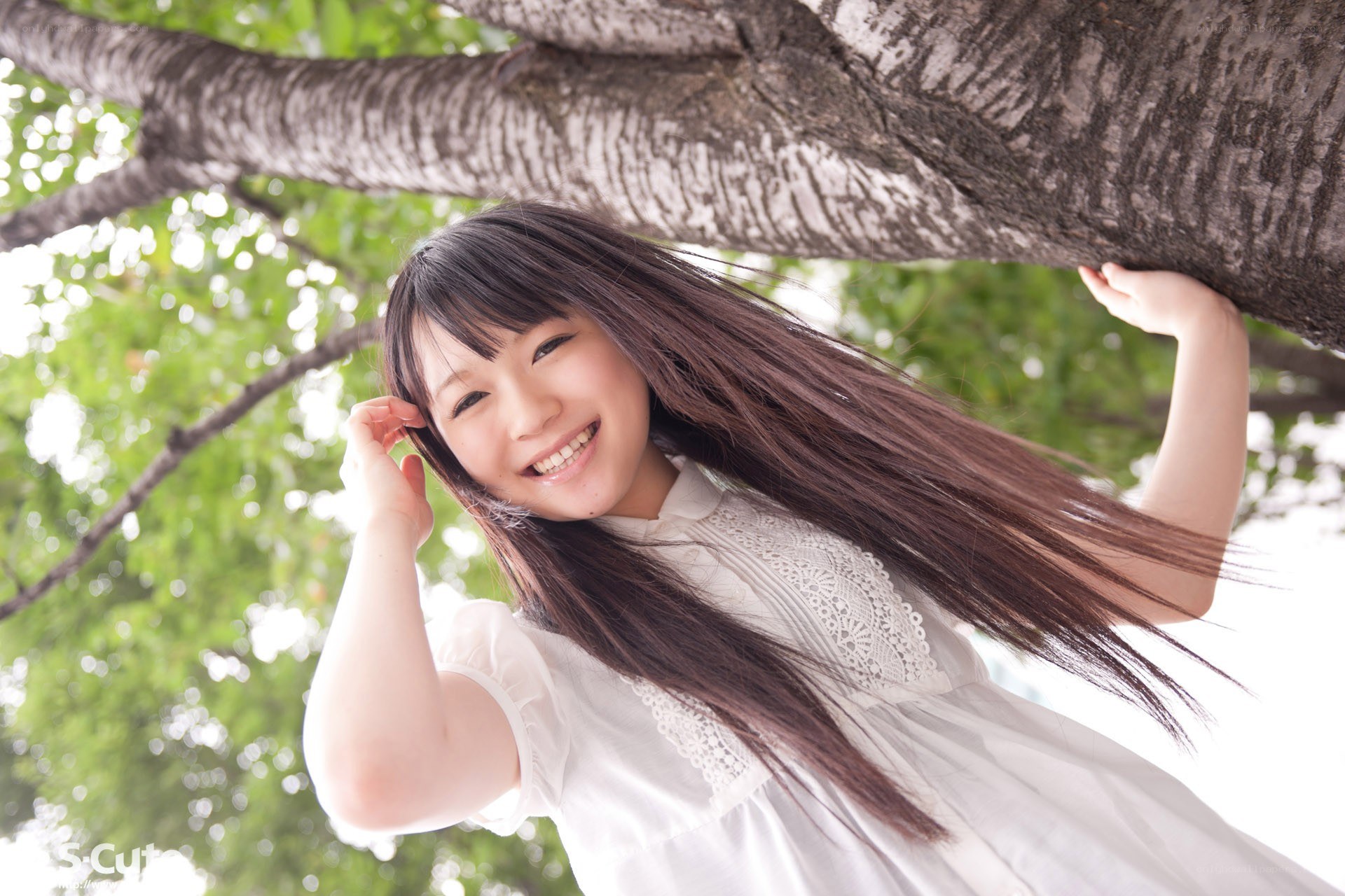 Smiling girl under a tree