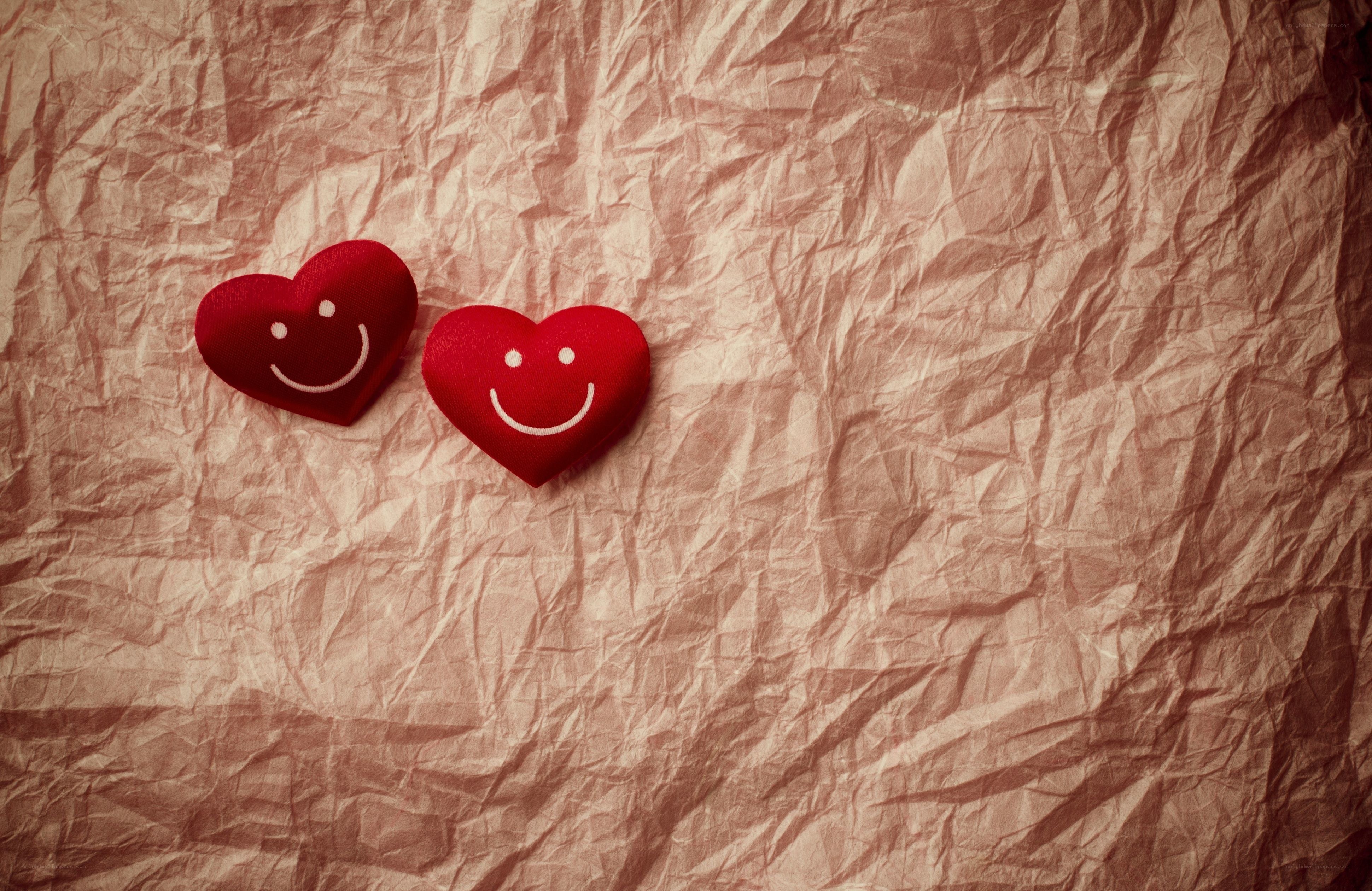 Smiling hearts on crumpled paper