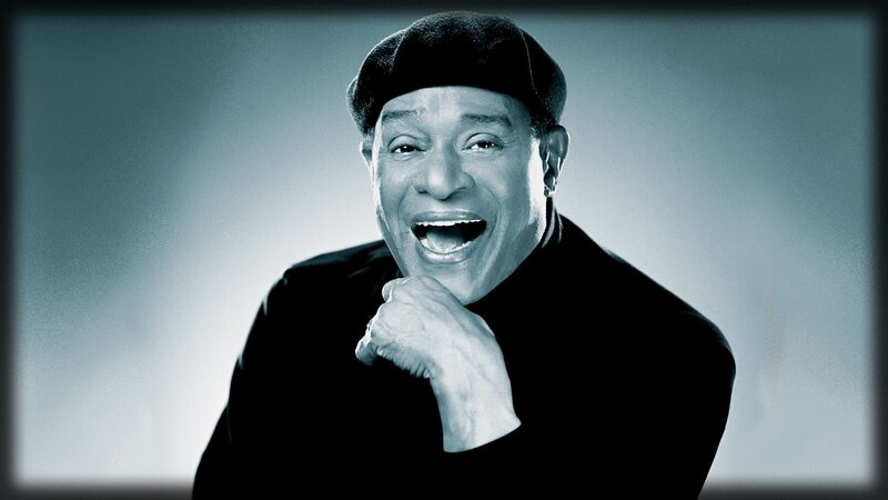 Smiling man in black hat