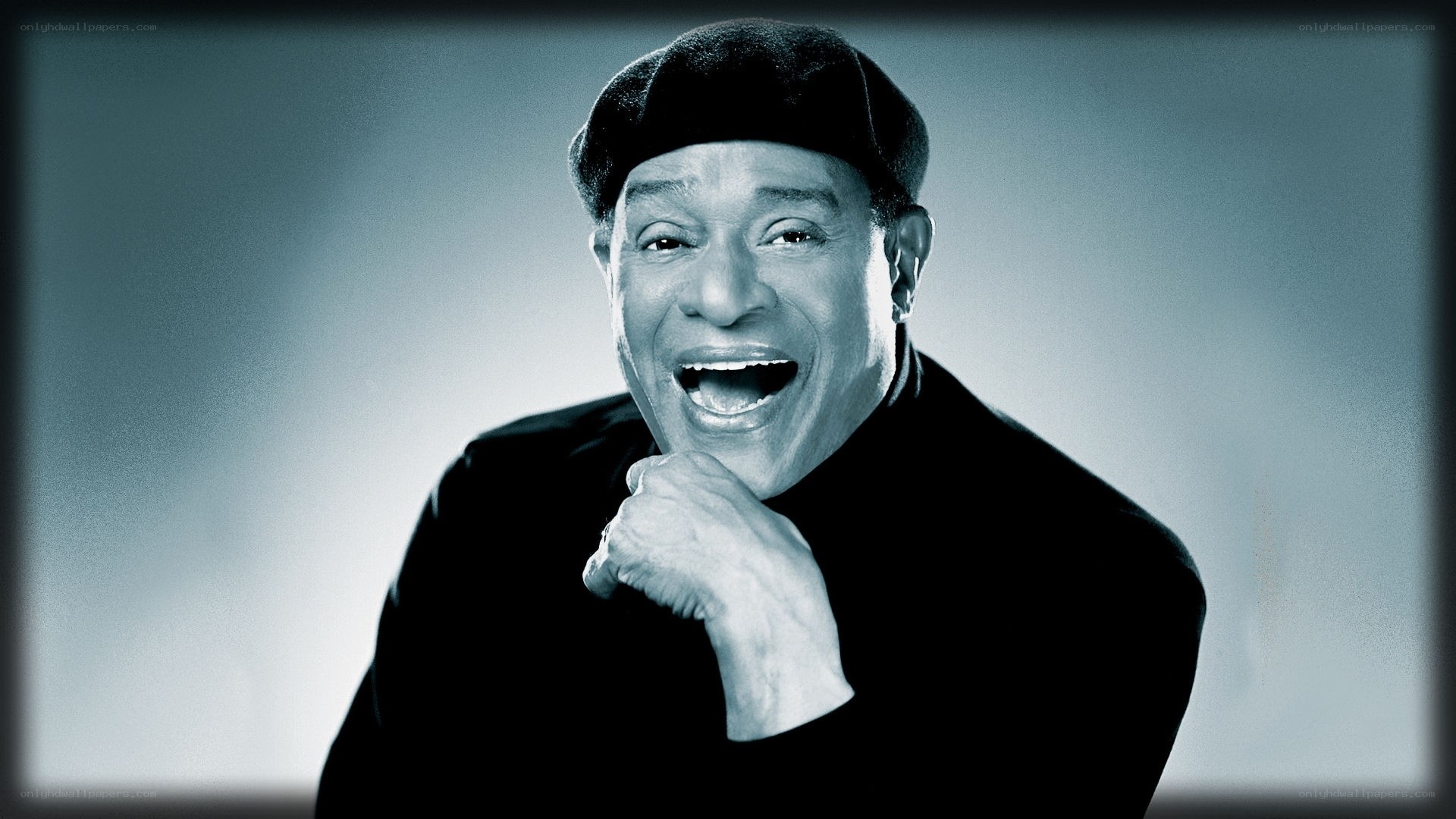 Smiling man in black hat