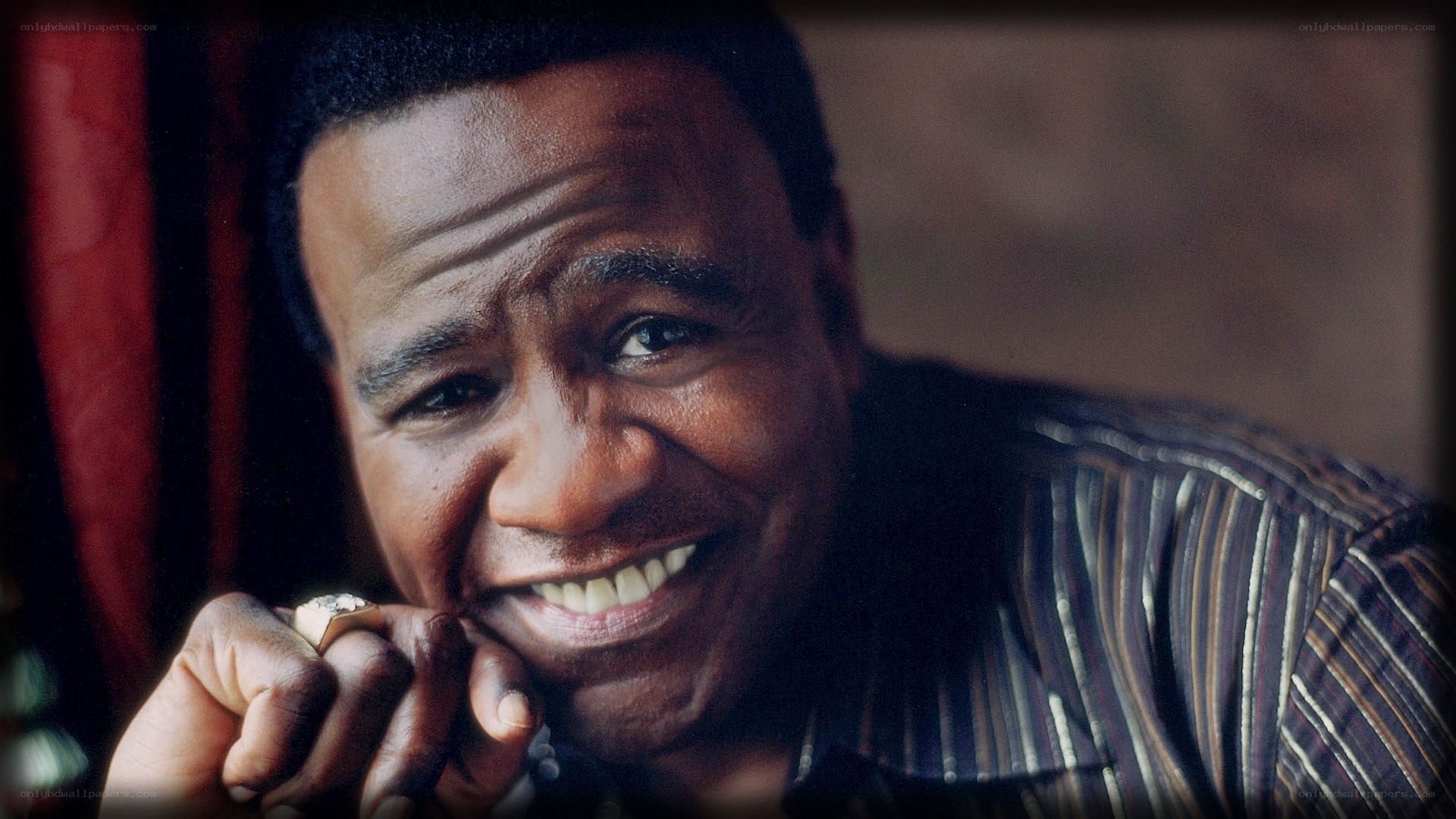 smiling man in striped shirt