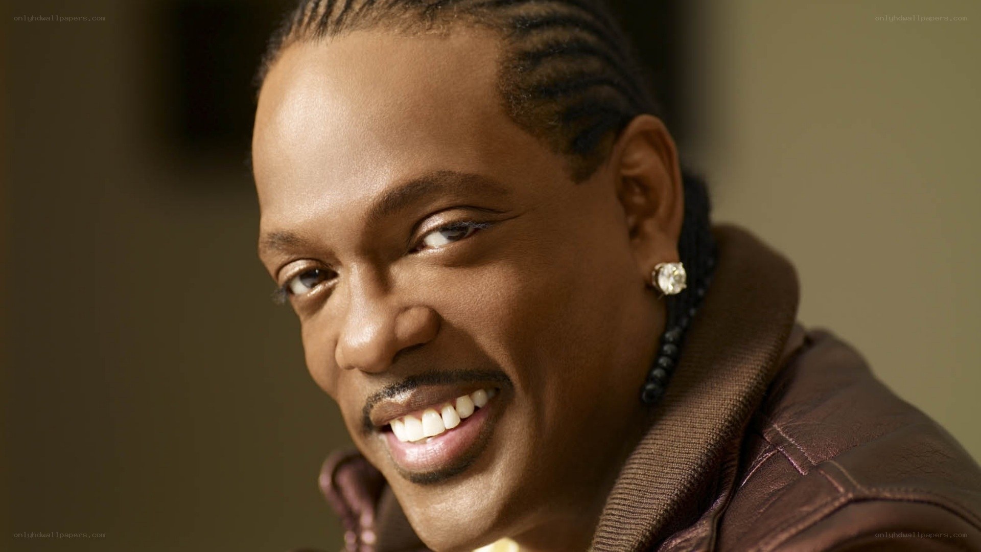 Smiling man with braided hair