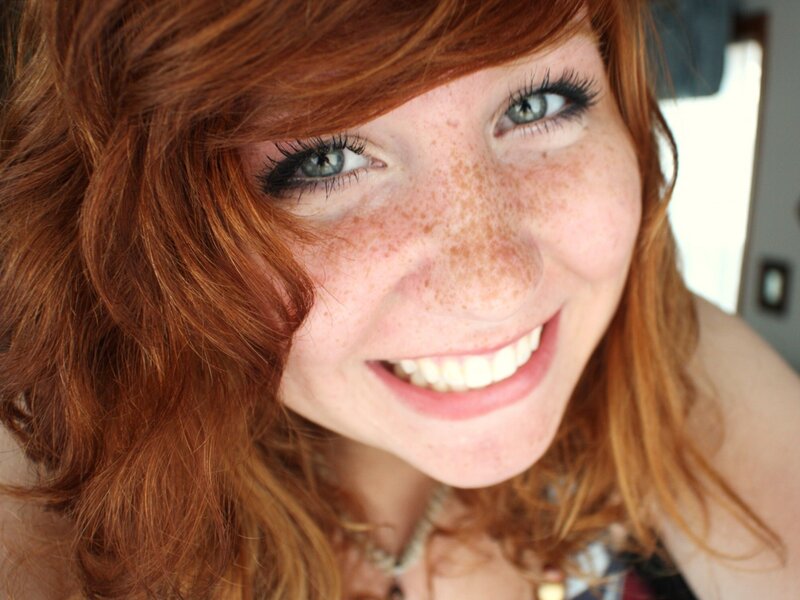 Smiling red-haired woman with freckles