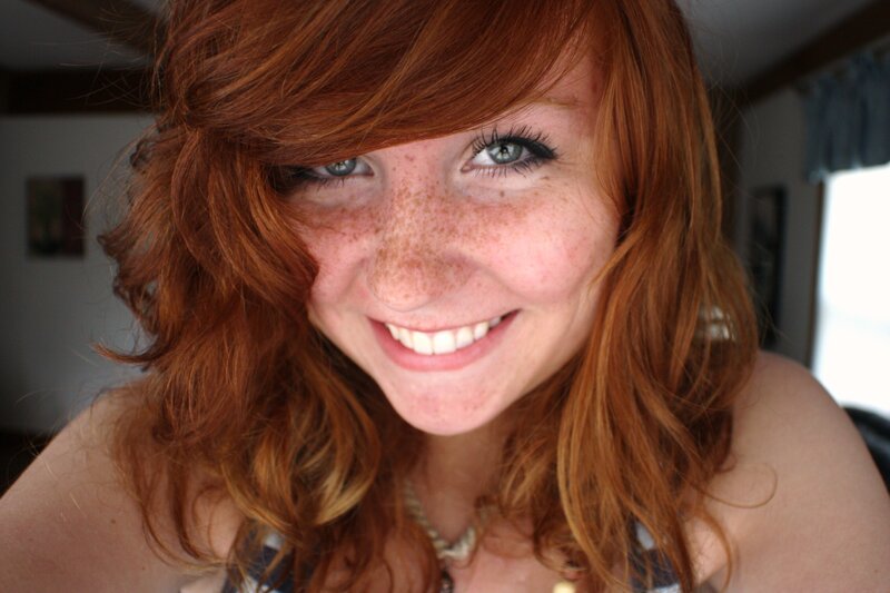 Smiling red-haired woman with freckles