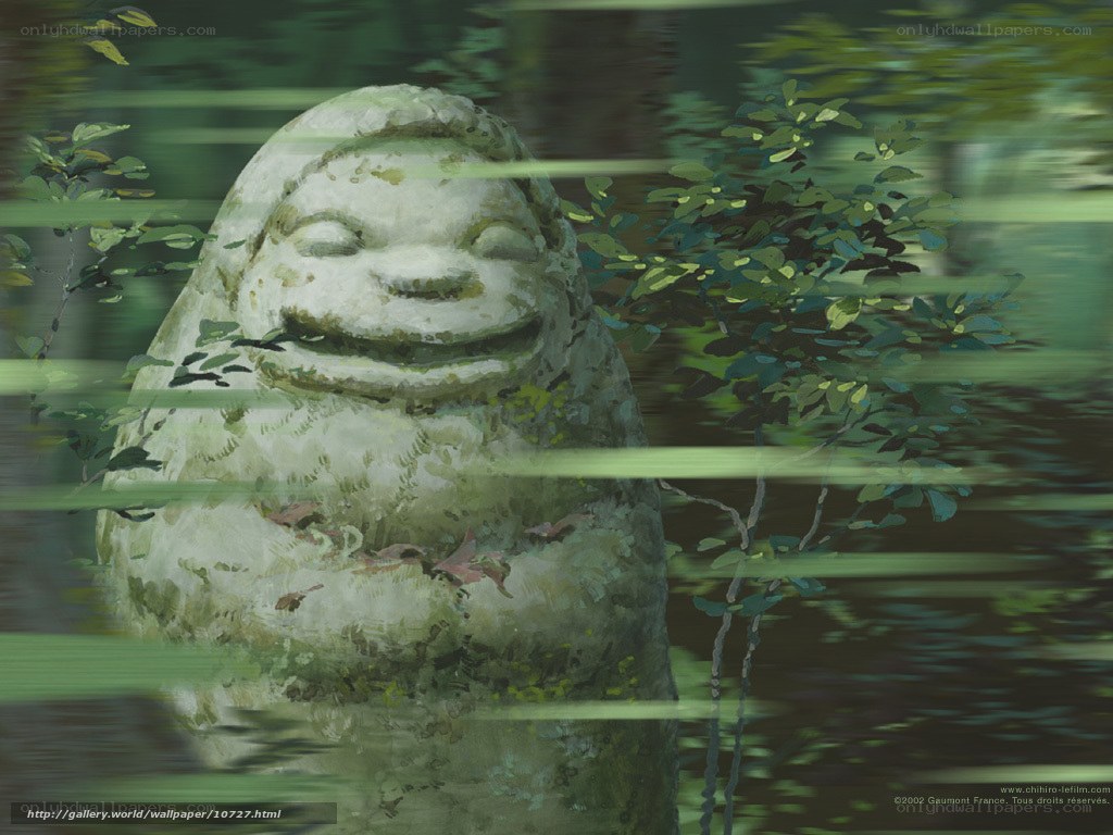Smiling stone statue in forest