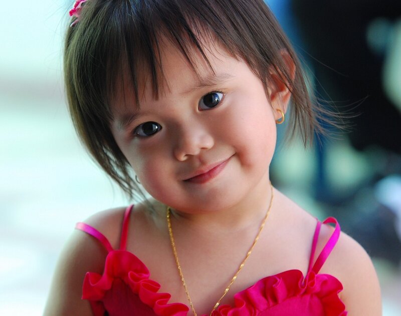smiling toddler in pink dress