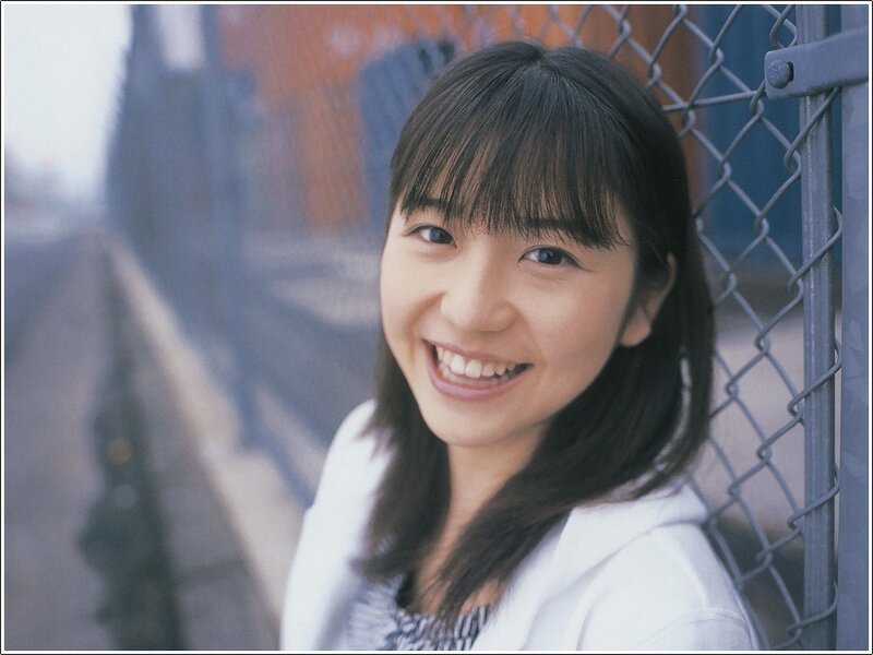 smiling woman by fence