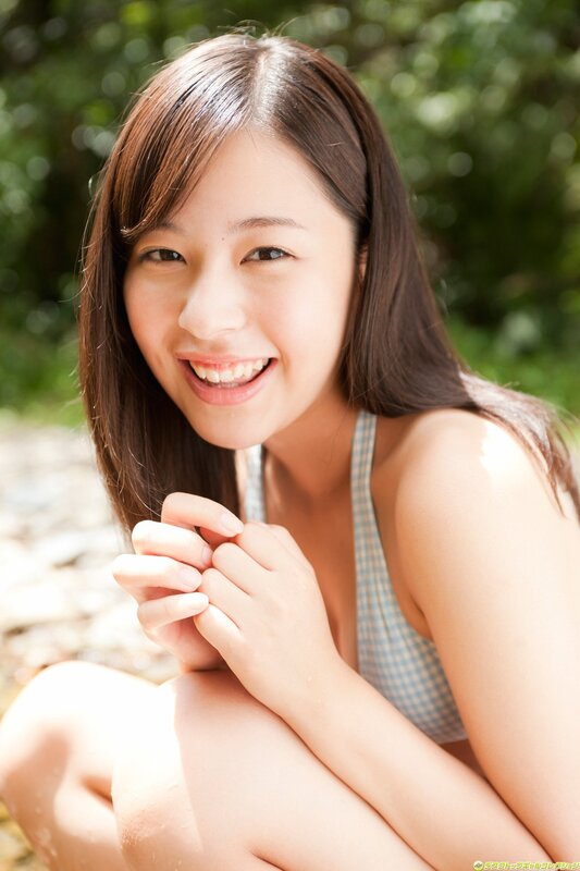 smiling woman in checkered top
