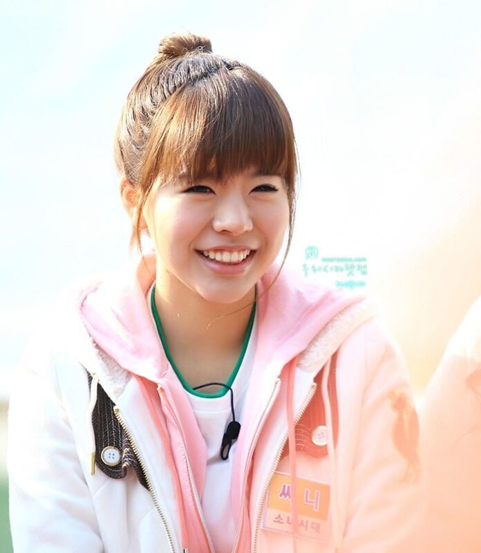 smiling woman in pink jacket