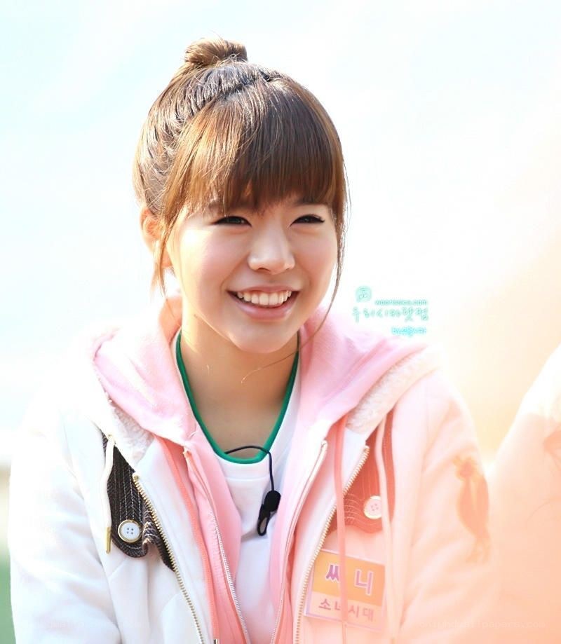 smiling woman in pink jacket