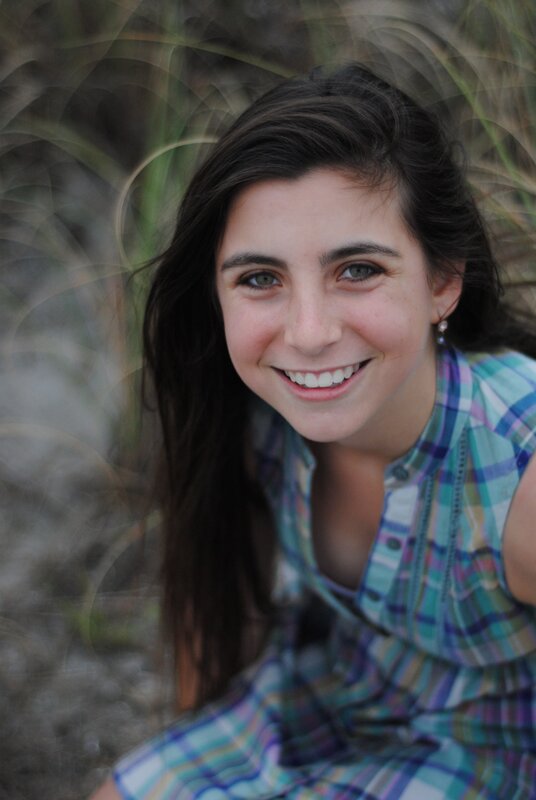 smiling woman in plaid shirt