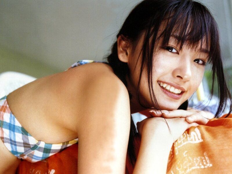 smiling woman in plaid top