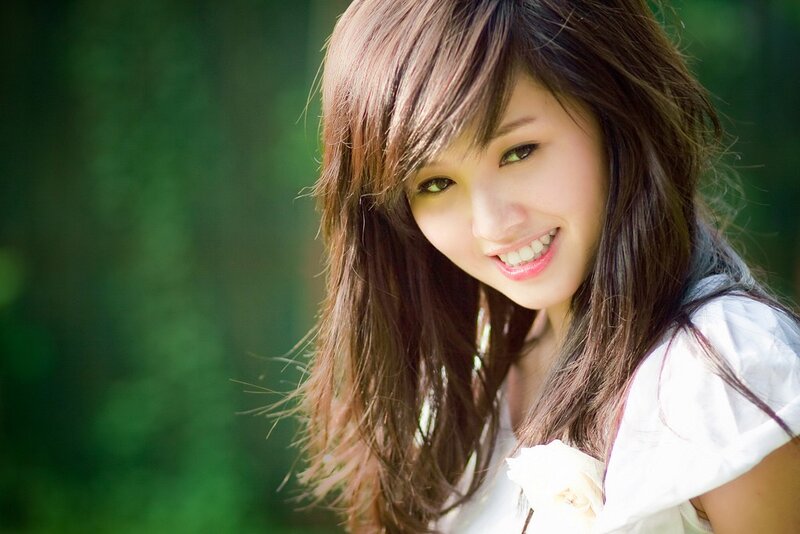smiling woman in white shirt