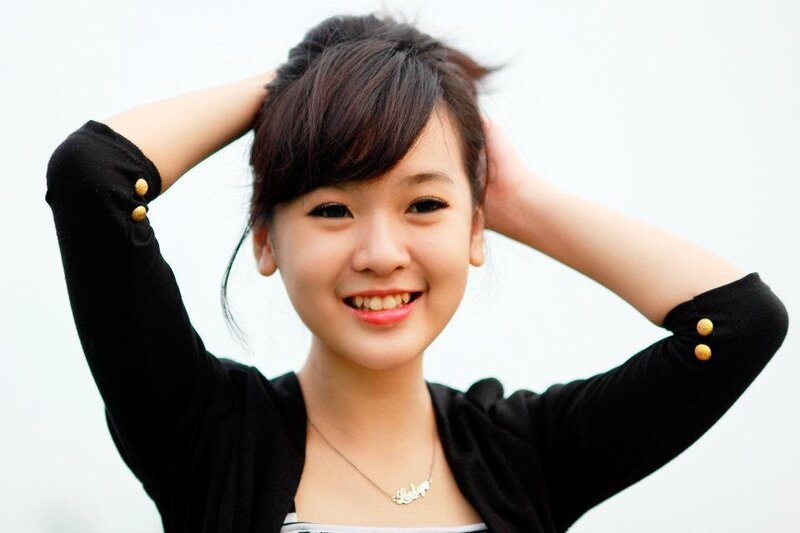 smiling woman with hands in hair