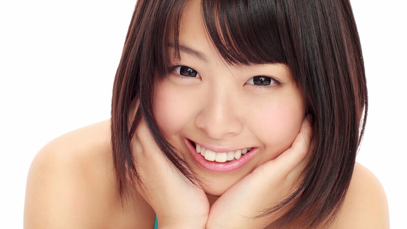 smiling woman with hands on cheeks