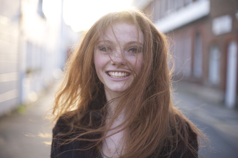 smiling woman with red hair