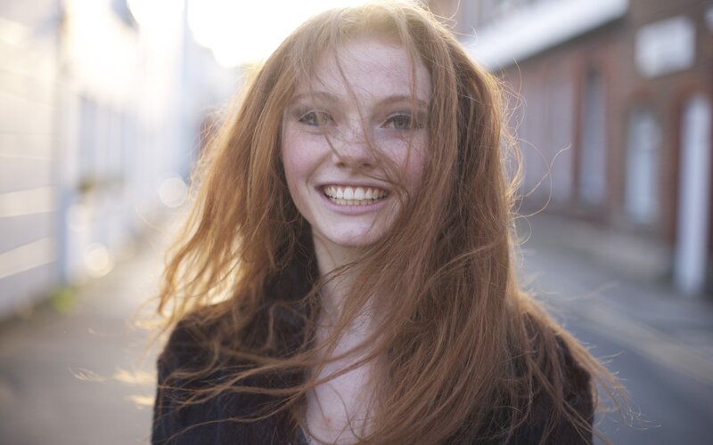 smiling woman with red hair