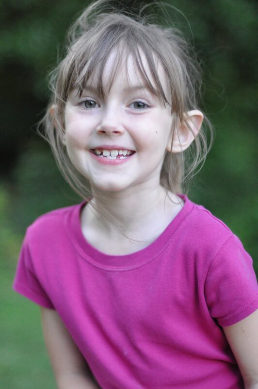 smiling young girl in pink shirt